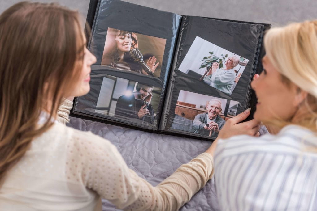 mother and daughter looking at photo album